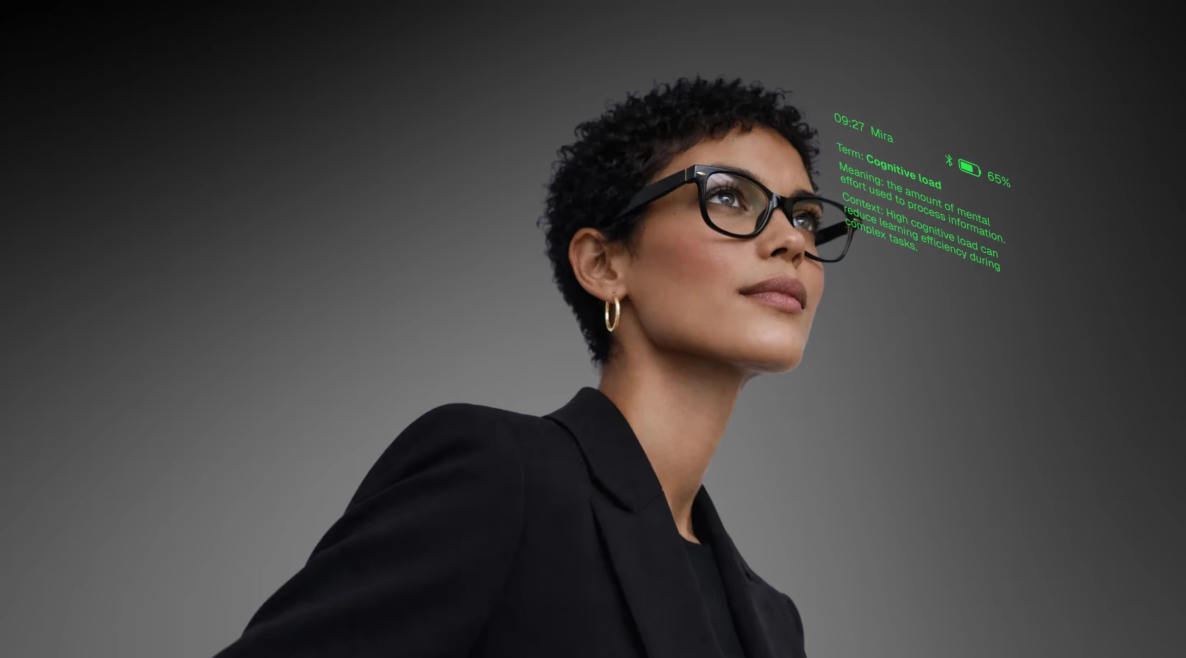 A woman in a dark jacket wearing MIRA glasses, with a green readout floating in the lens