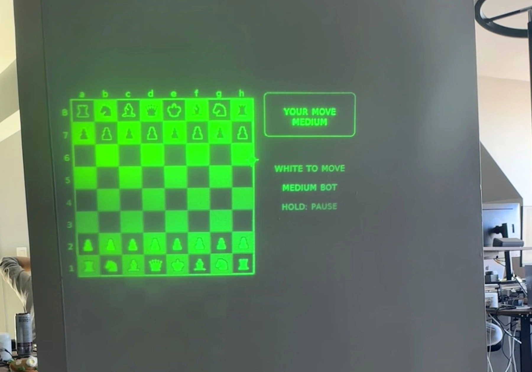 A green chess board shown on a wall by a MIRA app